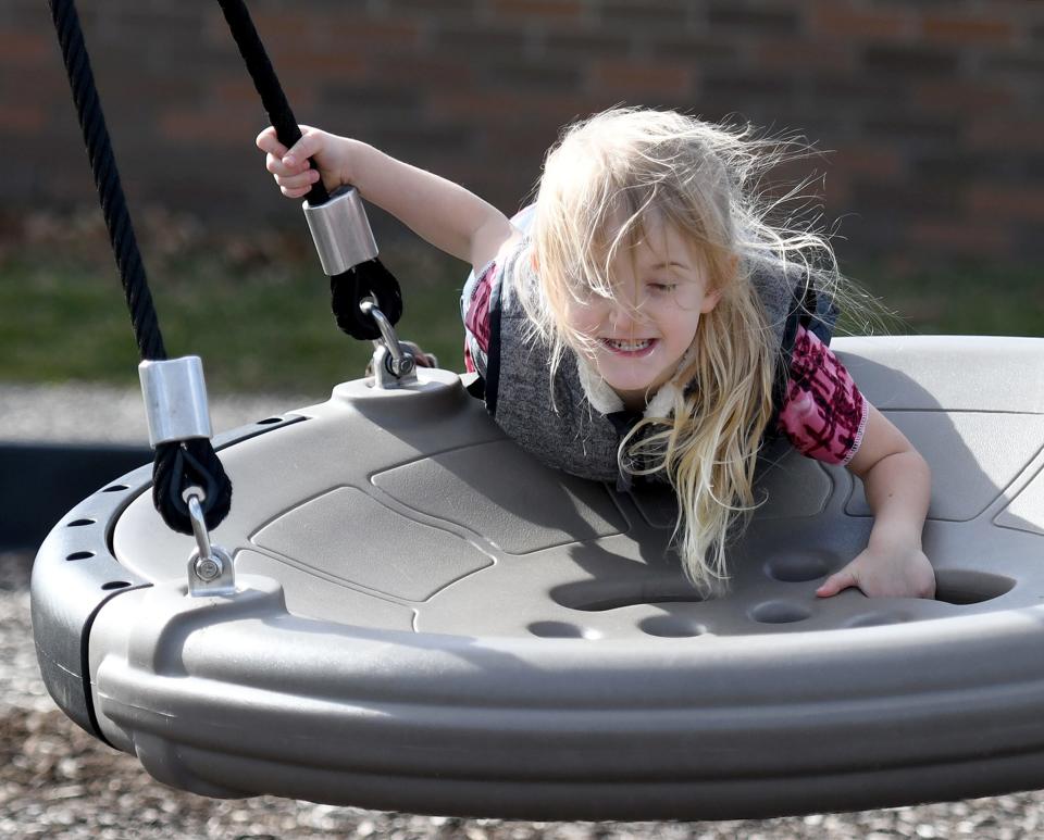 Aaliyah Kauffman, 4 of Canton is windblown while enjoying a warm day at Weis Park in Canton.  Thursday,  February 23, 2023.