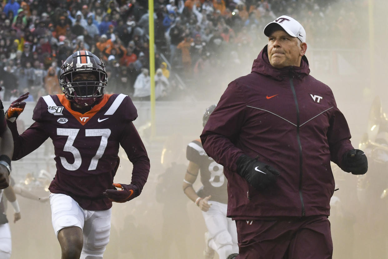 BLACKSBURG, VA - NOVEMBER 23: Head coach Justin Fuente of the Virginia Tech Hokies and defensive back Brion Murray #37 of the Virginia Tech Hokies run onto the field prior to the game against the Pittsburgh Panthers at Lane Stadium on November 23, 2019 in Blacksburg, Virginia. (Photo by Michael Shroyer/Getty Images)