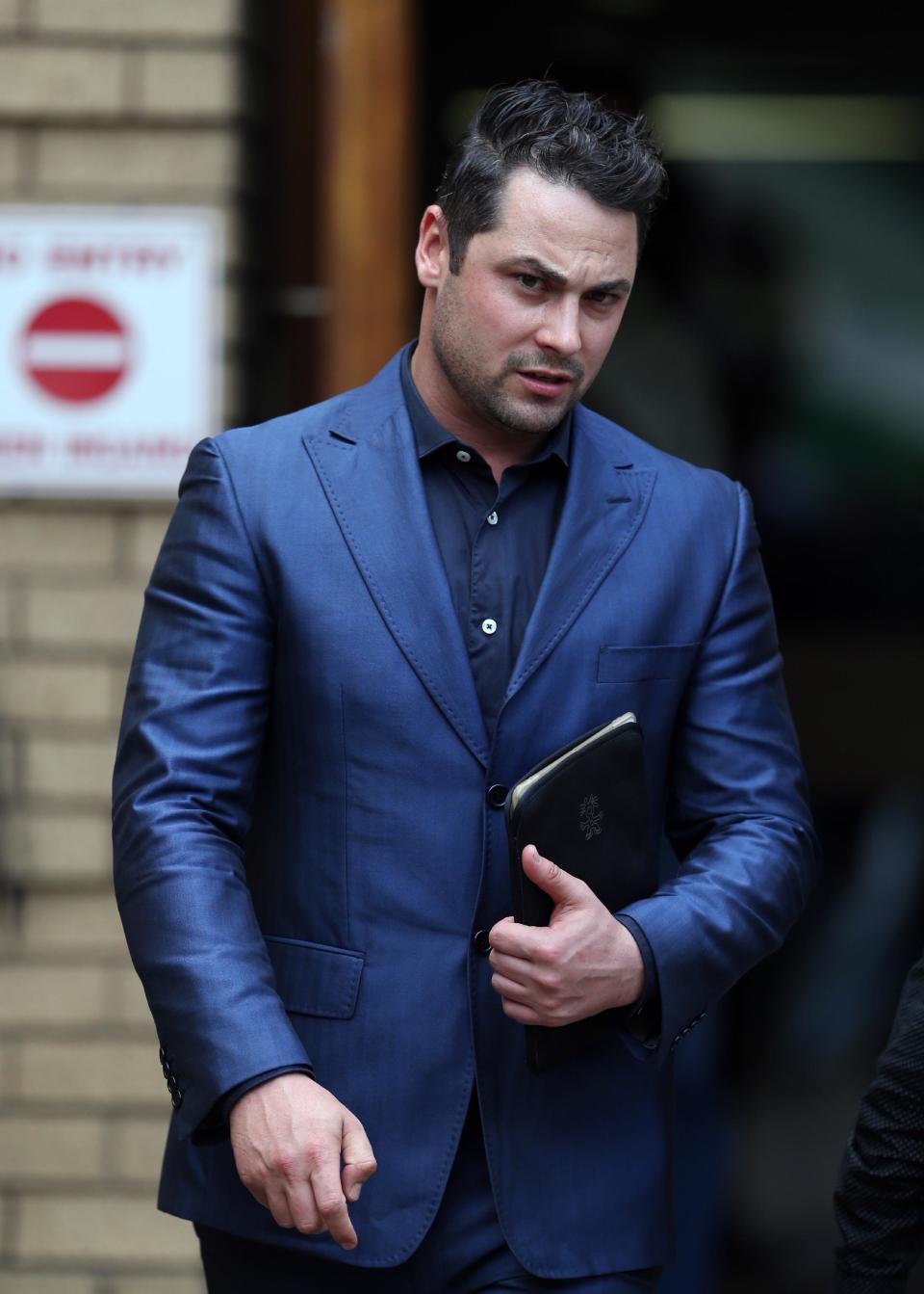 Oscar Pistorius's brother Carl Pistorius, leaves the high court in Pretoria, South Africa, Tuesday, April 15, 2014. Pistorius is charged with murder for the shooting death of his girlfriend, Reeva Steenkamp, on Valentines Day in 2013. (AP Photo/Themba Hadebe)