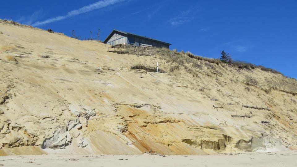 Hoping for a few more summers: A house on the edge along a Wellfleet beach.