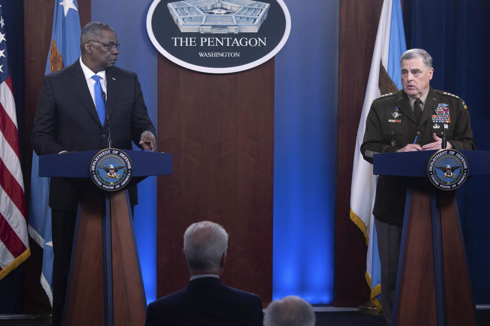 Defense Secretary Lloyd Austin, left, looks towards Joint Chiefs Chairman Gen. Mark Milley as he speaks during a press briefing at the Pentagon, Wednesday, July 21, 2021 in Washington. (AP Photo/Kevin Wolf)