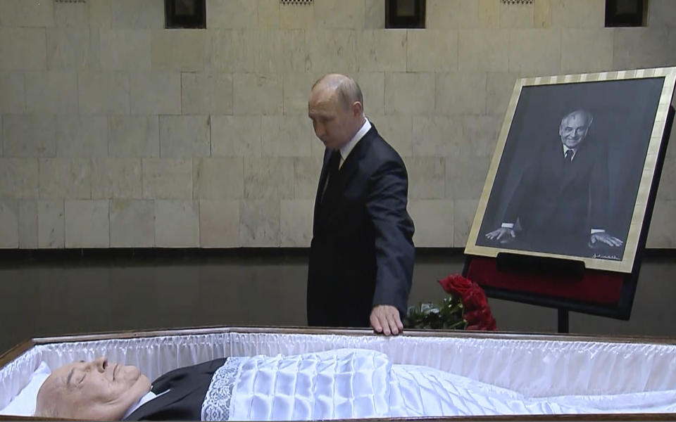 In this image taken from video provided by the Russian pool television on Thursday, Sept. 1, 2022, Russian President Vladimir Putin pays his last respect near the coffin of former Soviet President Mikhail Gorbachev at the Central Clinical Hospital in Moscow Russia. (Russian pool via AP)