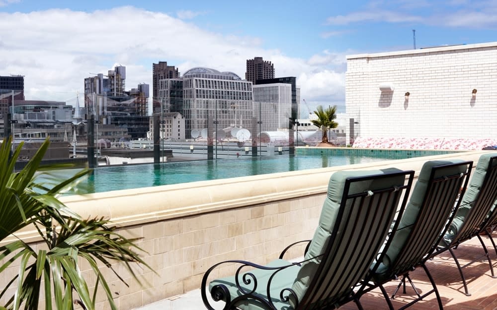 The Ned, London rooftop pool with loungers and skyline view