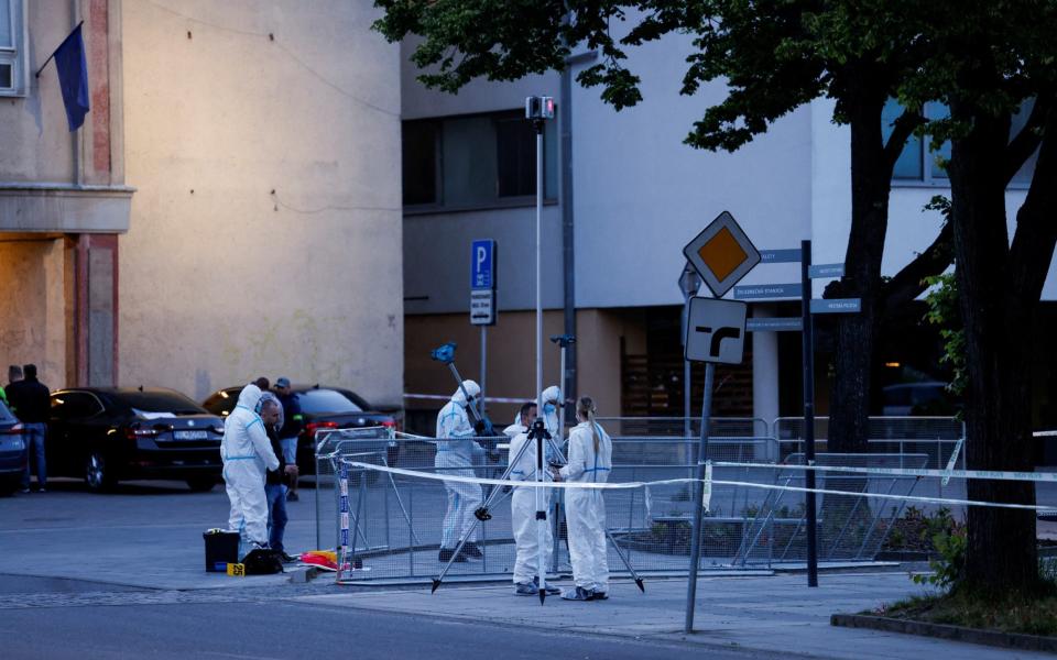 Police work at the scene after a shooting incident in which Slovak Prime Minister Robert Fico was wounded