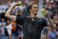 Alexander Zverev, of Germany, throws game balls to the crowd after defeating Lloyd Harris, of South Africa, during the quarterfinals of the US Open tennis championships, Wednesday, Sept. 8, 2021, in New York. (AP Photo/Elise Amendola)