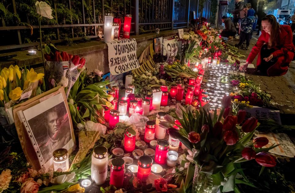 Flowers, candles and photos of Russian opposition leader Alexei Navalny are laid at the fence of the now-closed Russian consulate in Frankfurt, Germany, Saturday, Feb. 17, 2024. Navalny, who as President Vladimir Putin's fiercest enemy fought official corruption and staged massive protests against the Kremlin, died Friday in the Arctic penal colony where he was serving a 19-year sentence, the Russian prison service said. He was 47. (AP Photo/Michael Probst)