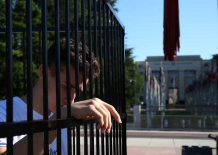 A teenager stands in a cage during a demonstration to condemn the US President Trump administrationÕs policy of child detention in Geneva