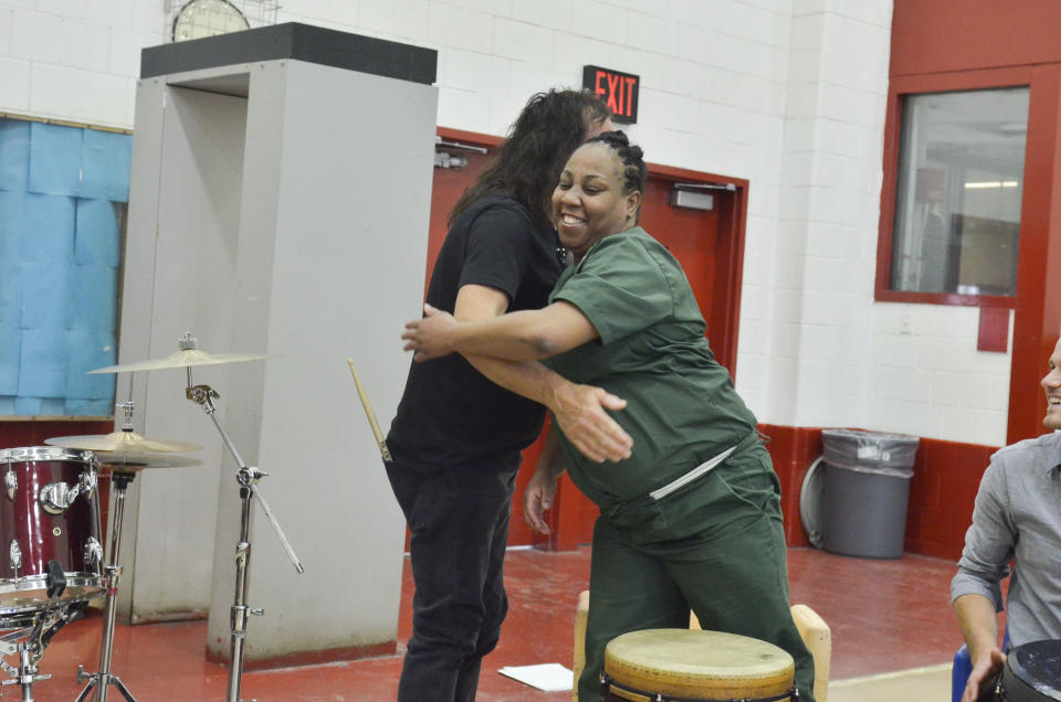Vinny Appice and inmate Vanessa Boomer exchange a warm hug after the performance.