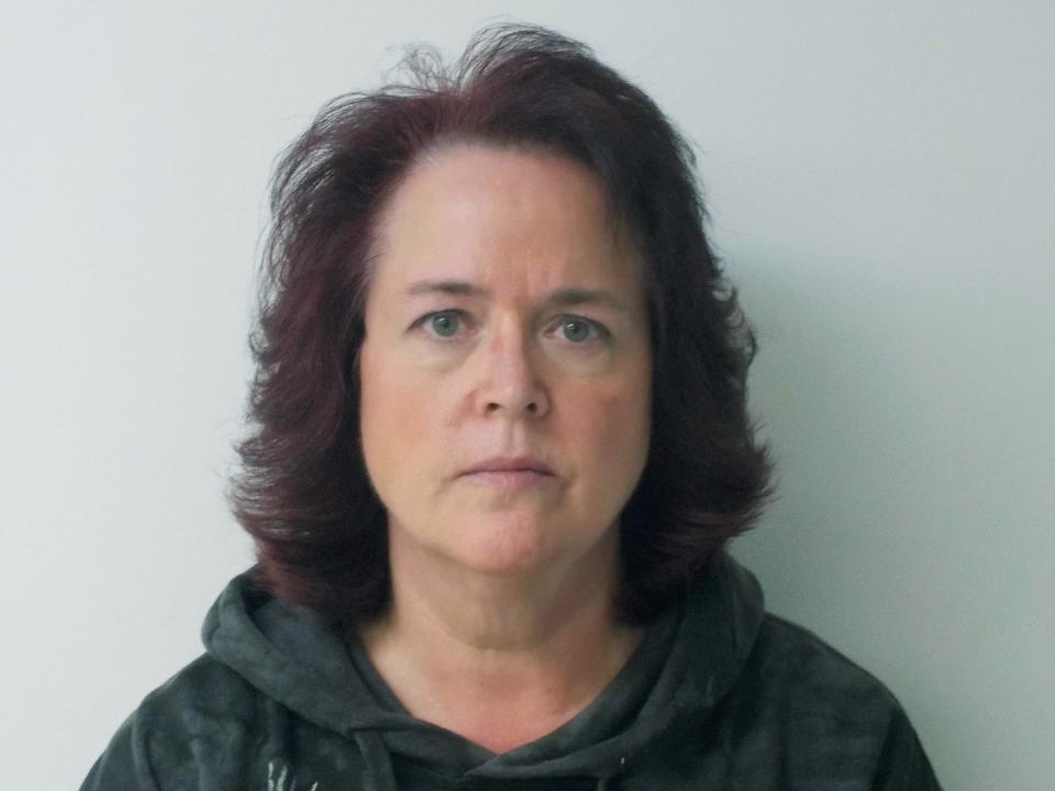 This Friday, Oct. 18, 2018 booking photo provided by New Boston Police shows Denise Atkocaitis, in New Boston, N.H. Atkocaitis, along with Thomas Atkocaitis, a married couple of New Boston, have been arrested and face several charges for allegedly constraining a girl to a small basement room for two months. (New Boston Police via AP)