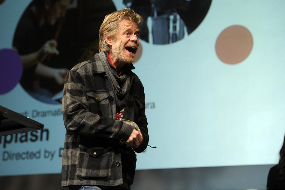 Presenter William H. Macy reacts as Damien Chazelle, director of "Whiplash," approaches the stage to accept the Audience Award: U.S. Dramatic for the film during the 2014 Sundance Film Festival Awards Ceremony on Saturday, Jan. 25, 2014, in Park City, Utah. (Photo by Chris Pizzello/Invision/AP)