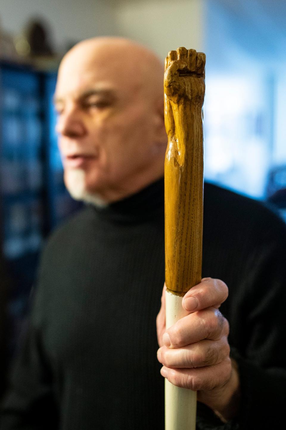 Stephen Handschu shows the details of a walking cane he made for self protection in 1977 at his apartment in Detroit on Wednesday, Nov. 8, 2023