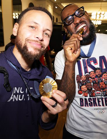 <p>Jim Poorten/NBAE via/Getty</p> Stephen Curry and LeBron James of the USA Men's National Team after winning the Gold against France on August 10, 2024 in Paris, France.