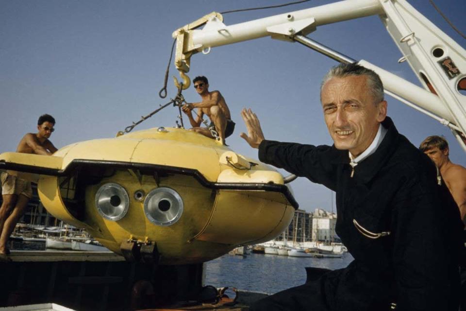 Jac Cousteau next to an underwater ship