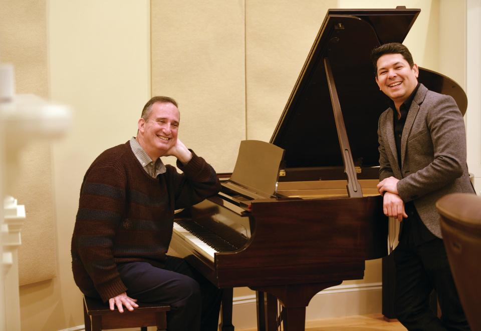 Paul Levenson, left, executive director of the Massachusetts Symphony Orchestra, with Jorge Soto at the Music Library at Worcester's Tuckerman Hall. Before conducting, Soto was a violinist for the orchestra.