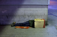 <p>A man sleeps inside a cardboard box in Madrid, Oct. 28, 2013. (AP Photo/Andres Kudacki) </p>