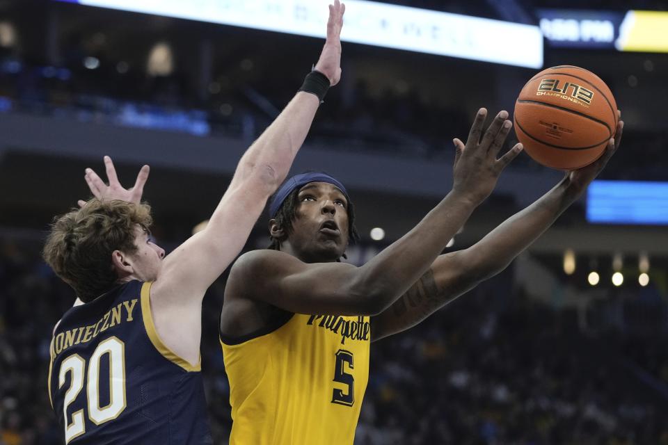 Marquette's Tre Norman shoots past Notre Dame's J.R. Konieczny during the first half of an NCAA college basketball game Saturday, Dec. 9, 2023, in Milwaukee. (AP Photo/Morry Gash)