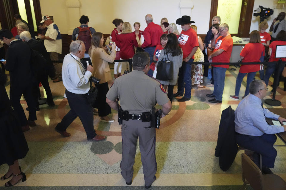 Members of the public line up outside the Texas State Senate Gallery waiting to enter for the start of the impeachment trial of Texas Attorney General Ken Paxton in Austin, Tuesday, Sept. 5, 2023. (AP Photo/LM Otero)