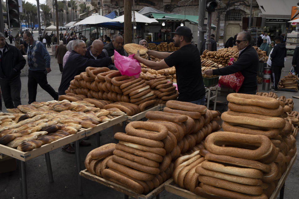 People buy bread after praying in the Al-Aqsa Mosque compound during the Muslim holy month of Ramadan in Jerusalem's Old City, Friday, March 15, 2024. (AP Photo/Leo Correa)