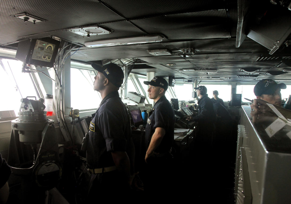 Naval officers stand inside U.S. Navy aircraft carrier USS NIMITZ (AP Photo/Rishi Lekhi)