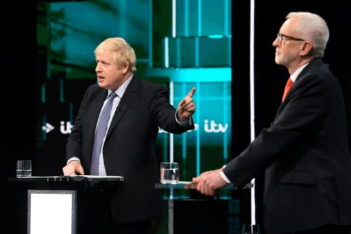 A handout picture taken and released by ITV shows Britain's Prime Minister Boris Johnson (L) and Britain's Labour Party leader Jeremy Corbyn (R) as they debate in Manchester