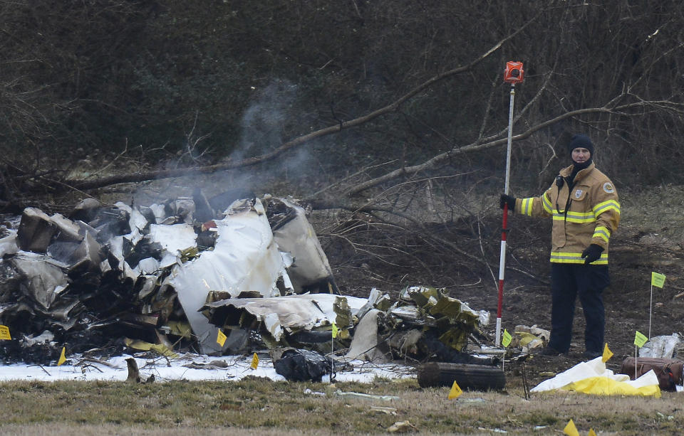 Investigators examine the site of a plane crash Tuesday, Feb. 4, 2014 near Nashville. (AP Photo/Mark Zaleski)