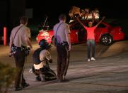 <p>St. Louis County and Dellwood police detain two people on Wednesday, August 13, 2014 in Ferguson, Missouri. Both people were released after being questioned. (Chris Lee/St. Louis Post-Distpatch//TNS/ZUMA Wire) </p>
