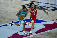 Memphis Grizzlies' De'Anthony Melton (0) brings the ball up court under pressure from New Orleans Pelicans' Lonzo Ball (2) during the first half of an NBA basketball game Monday, Aug. 3, 2020 in Lake Buena Vista, Fla. (AP Photo/Ashley Landis, Pool)