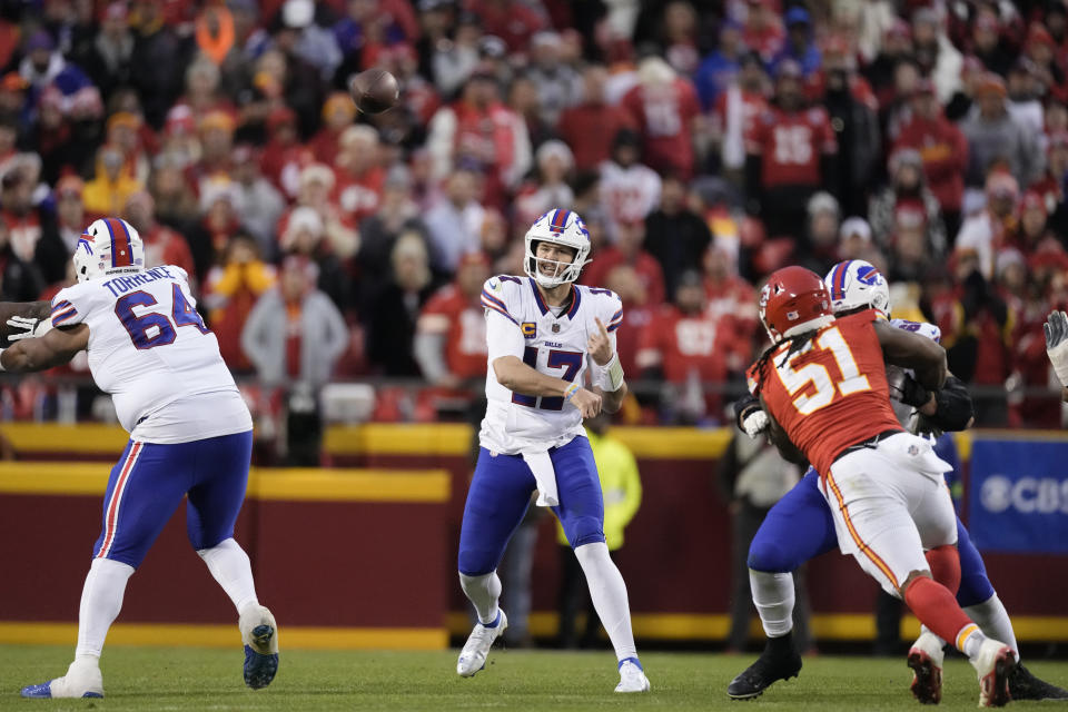 Buffalo Bills quarterback Josh Allen (17) throws under pressure from Kansas City Chiefs defensive end Mike Danna (51) during the first half of an NFL football game Sunday, Dec. 10, 2023, in Kansas City, Mo. (AP Photo/Charlie Riedel)