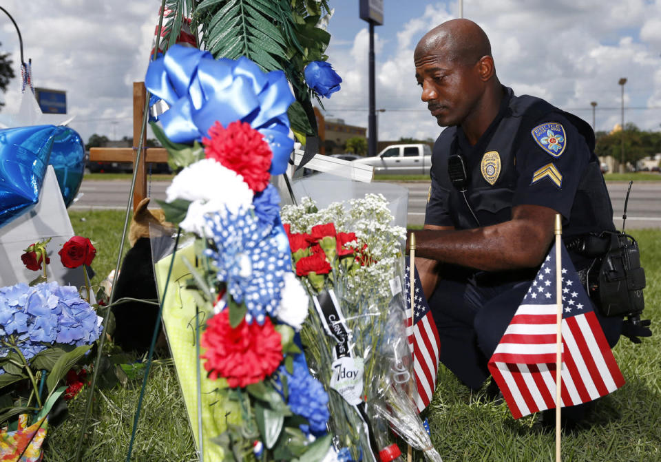 Cpl. Joseph Keller of the Baton Rouge police department pays respects