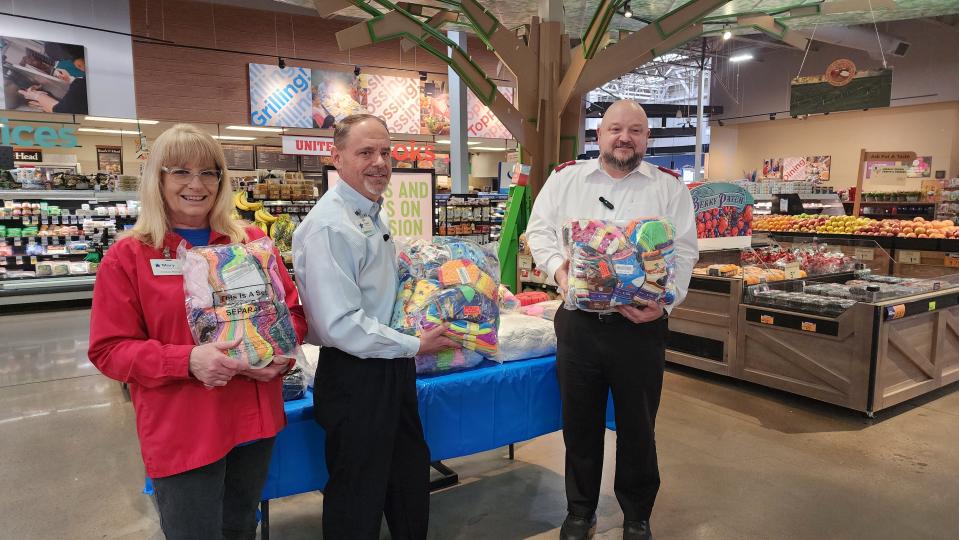 Major Tex Ellis, right, stands with Dustin Kyle, the United Supermarkets store director for Soncy Road and the produce manager, Thursday for a donation of socks for the Salvation Army in Amarillo.