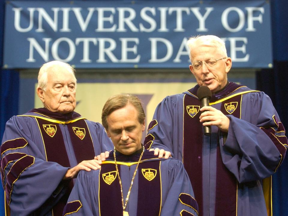 The Rev. Theodore M. Hesburgh, left, and the Rev. Edward A. Malloy, right, former presidents of the University of Notre Dame, bestow a blessing Sept. 23, 2005, on the Rev. John I. Jenkins during his inauguration ceremony as the university's 17th president.





The Reverend Theodore M. Hesburgh, C.S.C (left) and The Reverend Edward A. Malloy, C.S.C.(right) commence the inauguration ceremony of Reverend John I. Jenkins, C.S.C. with their words of encouragement on his years to come as President of Notre Dame. News. Photo by kohl threlkeld. 9/23/05. cq.