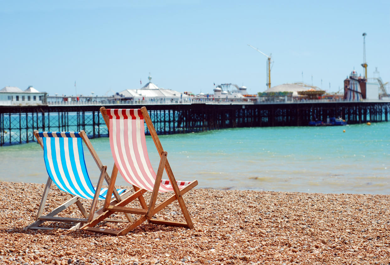 deck chairs on the beach Brighton England with blue sky