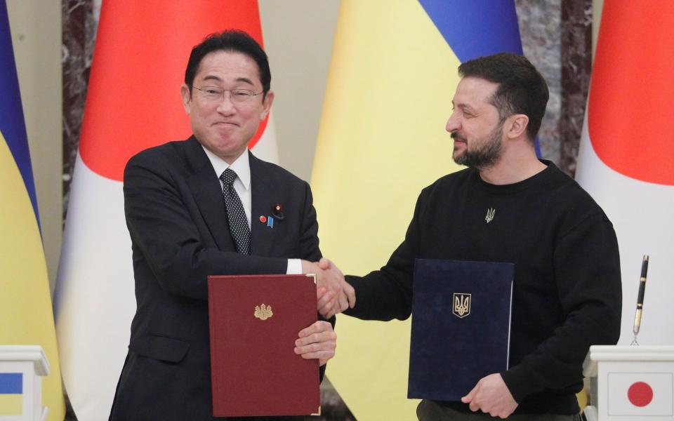 Japanese Prime Minister Fumio Kishida exchanges documents with Ukraine's President Volodymyr Zelensky - SERGEY DOLZHENKO/EPA-EFE/Shutterstock