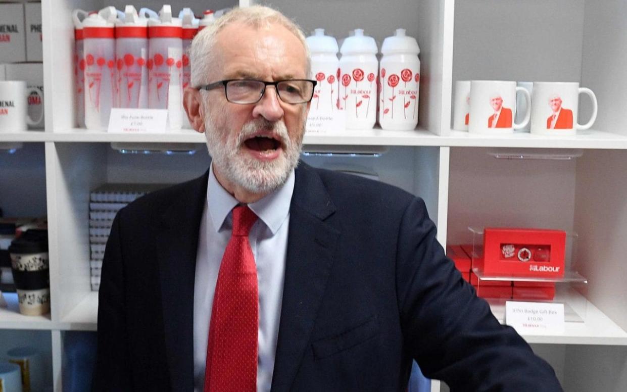 Tensions run high: Labour leader Jeremy Corbyn remonstrates with members of the media at the party conference in Brighton - AFP