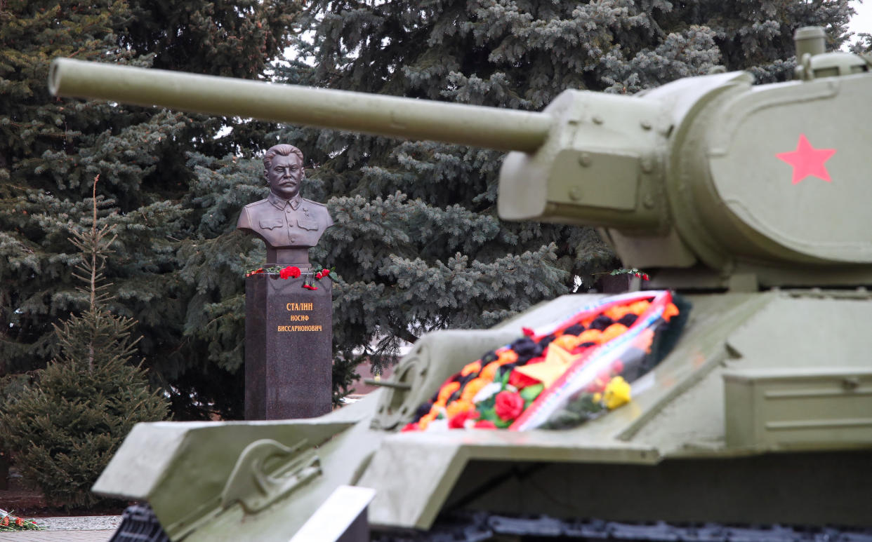 A bronze bust of Joseph Stalin is seen behind a tank at a museum.