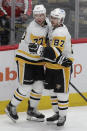 Pittsburgh Penguins' Jeff Carter (77) celebrates with teammate Sidney Crosby (87) after scoring on an empty net against the Washington Capitals during the third period of an NHL hockey game, Friday, Dec. 10, 2021, in Washington. (AP Photo/Luis M. Alvarez)