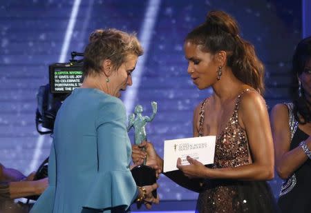 24th Screen Actors Guild Awards – Show – Los Angeles, California, U.S., 21/01/2018 – Actress Halle Berry (R) presents Frances McDormand with the award for Outstanding Performance by a Female Actor in a Leading Role for "Three Billboards Outside Ebbing, Missouri." REUTERS/Mario Anzuoni