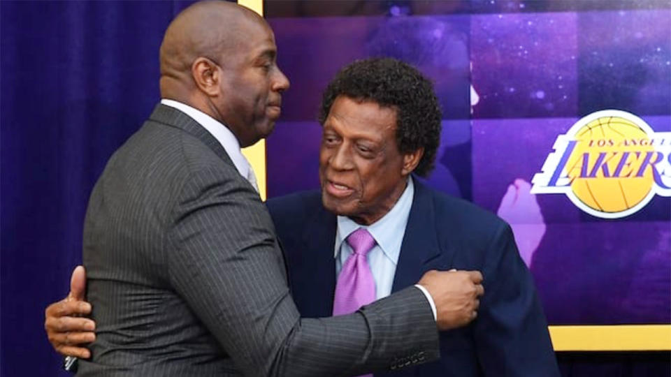 Pictured here, Los Angeles Lakers greats Magic Johnson and Elgin Baylor share a hug.