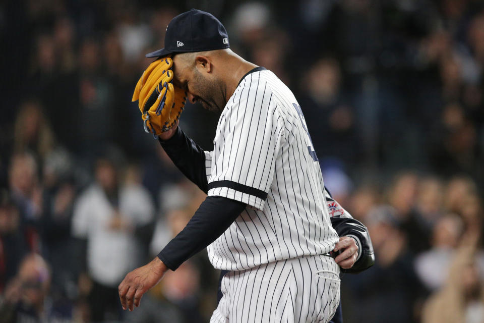 Oct 17, 2019; Bronx, NY, USA; New York Yankees pitcher CC Sabathia (52) reacts as he is walked off the field by trainer Steve Donohue after suffering an apparent injury against the Houston Astros during the eighth inning of game four of the 2019 ALCS playoff baseball series at Yankee Stadium. Mandatory Credit: Brad Penner-USA TODAY Sports