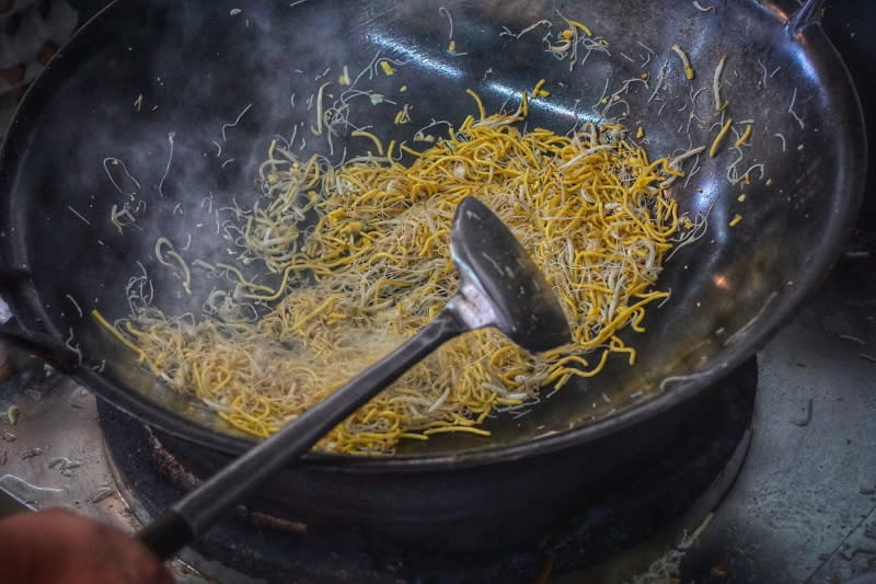 Stir-frying noodles in wok