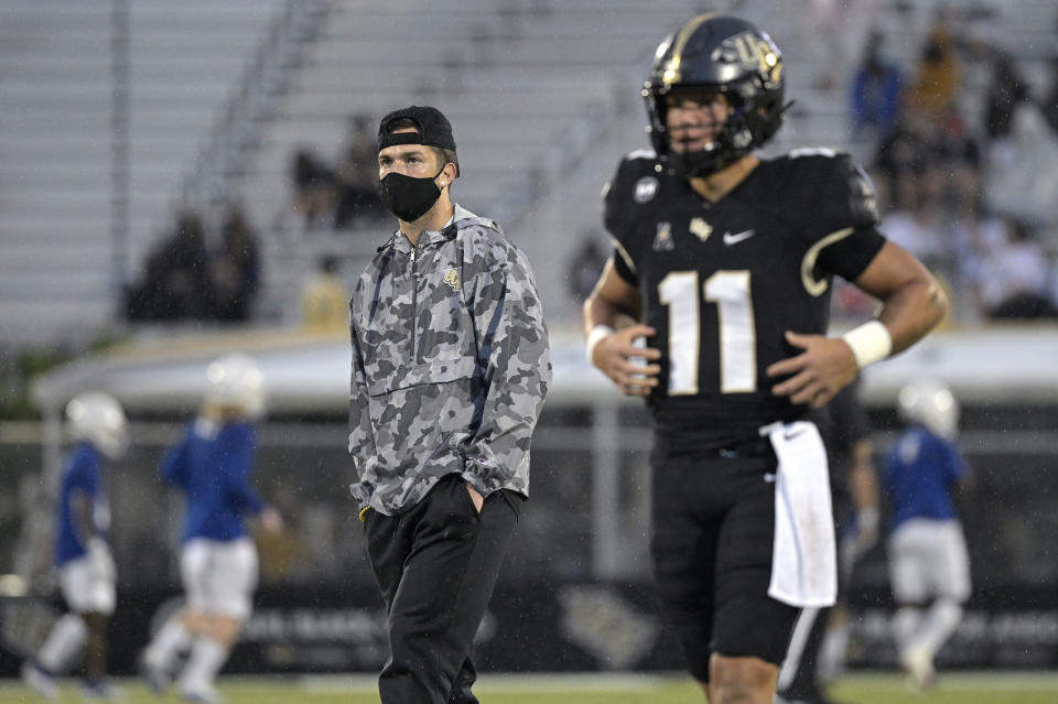 Central Florida quarterback McKenzie Milton, left, watches quarterback Dillon Gabriel (11) before an NCAA college football game against Tulsa, Saturday, Oct. 3, 2020, in Orlando, Fla. (AP Photo/Phelan M. Ebenhack)