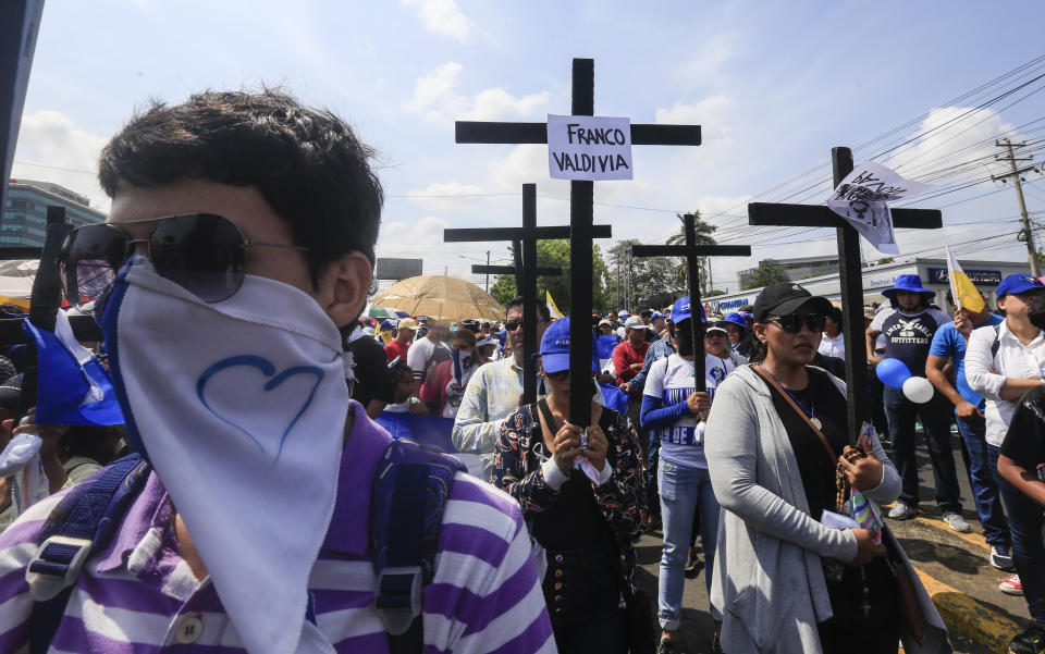 Anti-government protesters join a Stations of the Cross procession on Good Friday, carrying signs demanding the release of political prisoners in Managua, Nicaragua, Friday, April 19, 2019. Good Friday religious processions in Nicaragua’s capital have taken a decidedly political tone as people have seized on a rare opportunity to renew protests against the government of President Daniel Ortega. (AP Photo/Alfredo Zuniga)