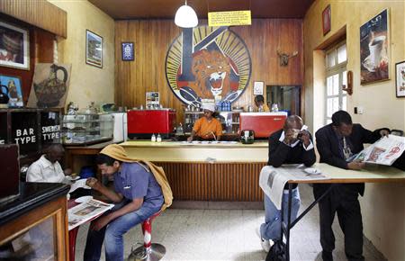 Customers drink coffee as they read newspapers at the Tamoka coffee bar in Ethiopia's capital Addis Ababa, September 16, 2013. REUTERS/Tiksa Negeri