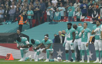 <p>Miami Dolphins’ Julius Thomas (89), Michael Thomas (31) and Kenny Stills take a knee as the U.S. national anthem is played before an NFL football game against the New Orleans Saints at Wembley Stadium in London, Sunday Oct. 1, 2017. (AP Photo/Matt Dunham) </p>