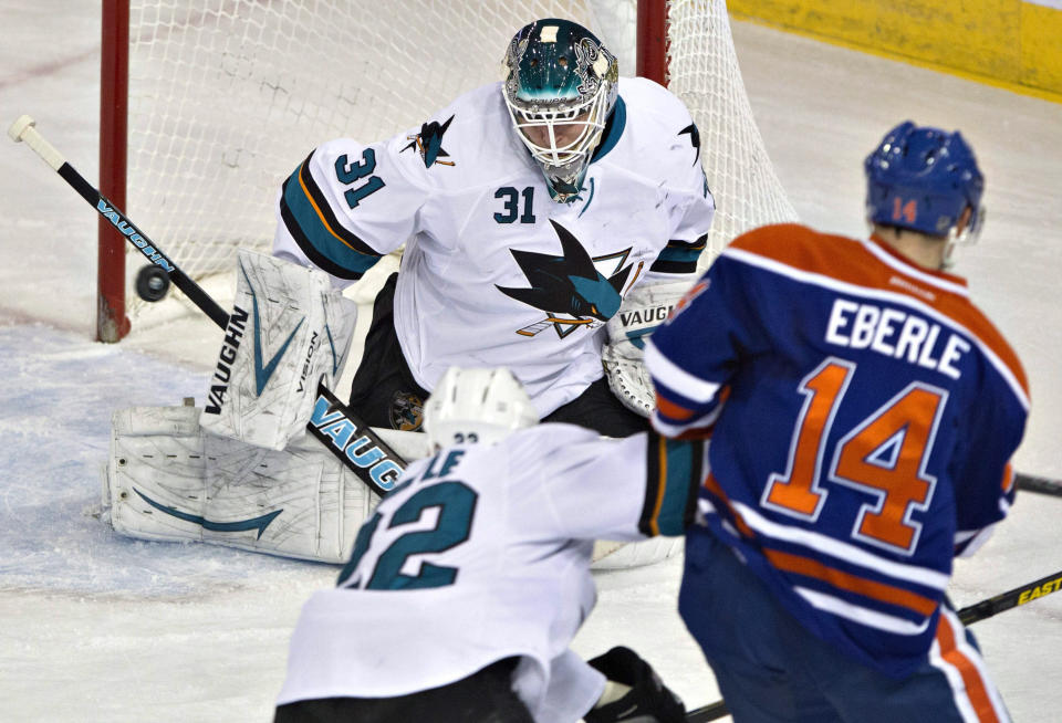 San Jose Sharks goalie Antti Niemi (31) makes the save on Edmonton Oilers Jordan Eberle (14) as Dan Boyle (22) defends during the second period of an NHL hockey game Wednesday, Jan. 29, 2014, in Edmonton, Alberta. (AP Photo/The Canadian Press, Jason Franson)