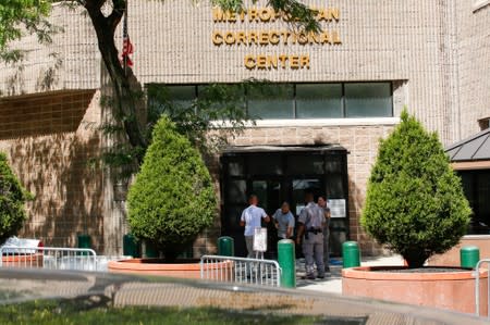 FILE PHOTO: Security personnel and people are seen at the entrance of the Metropolitan Correctional Center jail where financier Epstein was found dead in the Manhattan borough of New York City, New York