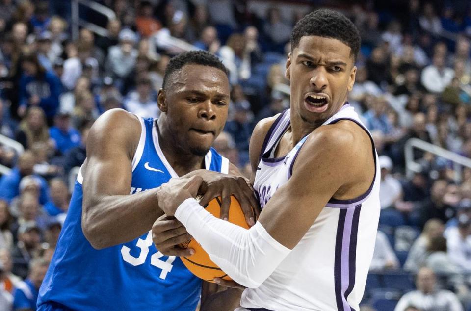 Kansas State’s David N’Guessan gets tied up with Kentucky’s Oscar Tshiebwe during the first half of their second round NCAA Tournament game in Greensboro, NC on Sunday.