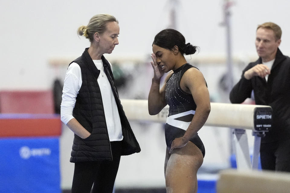 Gabby Douglas, center, talks with Anna Kotchneva during a break in competition at the American Classic Saturday, April 27, 2024, in Katy, Texas. (AP Photo/David J. Phillip)