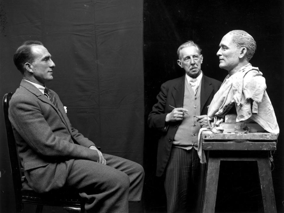 22nd April 1930: Footballer Tom Parker, captain of Arsenal, sitting for waxwork maker John Tussaud, who is crafting his likeness for a model at Madame Tussaud's.