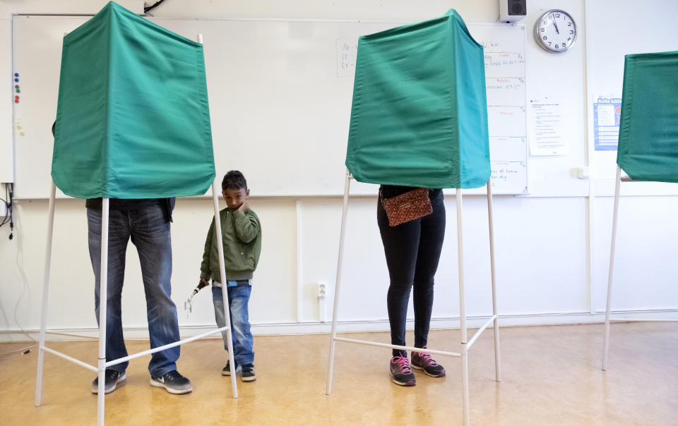 A child waits for his father to vote in Malmo, Sweden, Sunday Sept. 9, 2018. Polls have opened in Sweden's general election in what is expected to be one of the most unpredictable and thrilling political races in Scandinavian country for decades amid heated discussion around top issue immigration. ( Johan Nilsson/TT via AP)